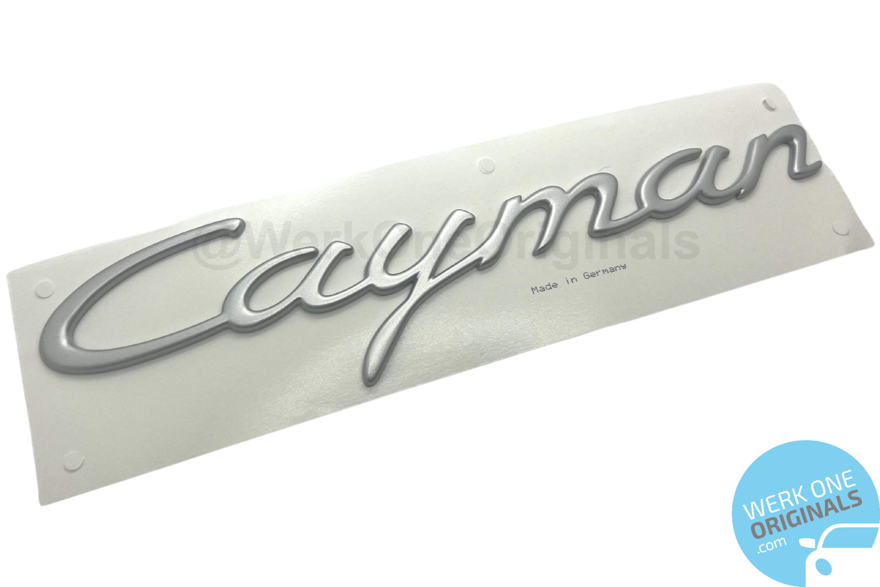 Official Porsche 'Cayman' Rear Badge in Satin Aluminium for Cayman Type 987 Models.